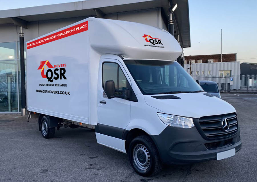Professional movers loading boxes into a moving truck